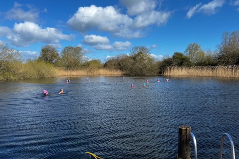 Cold waters swimmers at the wild swimming lake at elmore estate